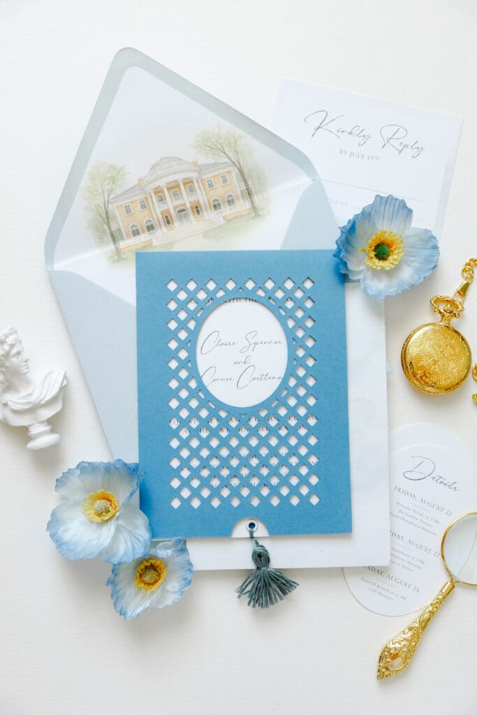 Custom blue wedding invitations with lattice gatefold, watercolor venue artwork and tassel closure